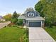 Two-story house with a blue exterior, a two-car garage, and landscaping at 823 Timothy Dr, Longmont, CO 80503