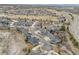 An aerial view featuring a large residential community with houses, golf course and roadways at 23753 E Kettle Pl, Aurora, CO 80016