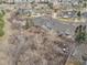An aerial view showcasing the home's setting nestled among mature trees and natural landscape at 23753 E Kettle Pl, Aurora, CO 80016