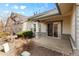 Covered back porch with stone pillars and sliding glass doors for seamless indoor-outdoor living at 23753 E Kettle Pl, Aurora, CO 80016