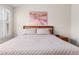 Bright bedroom featuring a window with shutters, a cozy bed, and a wall art piece at 23753 E Kettle Pl, Aurora, CO 80016