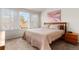 Comfortable bedroom showcasing a large window with shutters and a neutral color palette at 23753 E Kettle Pl, Aurora, CO 80016