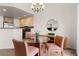 Dining area featuring a glass table, three chairs, a mirror and a sideboard at 23753 E Kettle Pl, Aurora, CO 80016