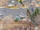 Well-maintained exterior with stone accents, manicured landscaping, and mature trees enhance curb appeal at 23753 E Kettle Pl, Aurora, CO 80016