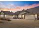 Beautiful single story home featuring a large driveway and attached garages at dusk at 23753 E Kettle Pl, Aurora, CO 80016