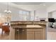 Bright kitchen featuring a breakfast bar with granite counters, a sink and stainless steel dishwasher at 23753 E Kettle Pl, Aurora, CO 80016
