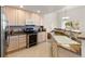 Well-equipped kitchen featuring wooden cabinets, granite countertops, and stainless steel appliances at 23753 E Kettle Pl, Aurora, CO 80016