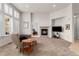 Comfortable living room featuring plush carpet, a fireplace, and large windows for natural light at 23753 E Kettle Pl, Aurora, CO 80016