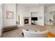 Inviting living room featuring plush carpet, a fireplace, and lots of natural light at 23753 E Kettle Pl, Aurora, CO 80016
