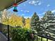 Balcony with flowers and a view of neighborhood trees and blue sky at 491 S Kalispell Way # 305, Aurora, CO 80017