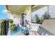 Cozy balcony with patio furniture, plants and storage shelf with watering can at 491 S Kalispell Way # 305, Aurora, CO 80017