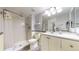 Bright bathroom featuring a stand-up shower, vanity with sink, toilet and white and yellow color scheme at 491 S Kalispell Way # 305, Aurora, CO 80017