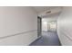 Hallway in building, with blue carpet and white walls and doors leading to apartment units at 491 S Kalispell Way # 305, Aurora, CO 80017