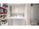 Functional laundry room featuring modern washer and dryer units and ample storage shelves at 491 S Kalispell Way # 305, Aurora, CO 80017