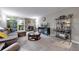 Bright living room with stone fireplace, balcony access, and elegant display shelving at 491 S Kalispell Way # 305, Aurora, CO 80017