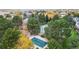 Overhead view of community pool, tennis courts, and clubhouse amidst lush greenery at 491 S Kalispell Way # 305, Aurora, CO 80017