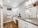 Bathroom featuring dual sinks, granite countertops, and a walk-in shower at 246 Ash St, Bennett, CO 80102