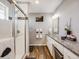 Bathroom showcasing a glass-enclosed shower, modern fixtures, and stylish decor at 246 Ash St, Bennett, CO 80102