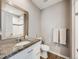 Clean bathroom featuring a granite counter, large mirror, and shower stall at 246 Ash St, Bennett, CO 80102