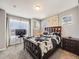 Cozy bedroom with large windows, dark wood furniture, and comfortable carpet at 246 Ash St, Bennett, CO 80102