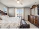 Bedroom featuring a large bed with dark wood furniture set, and a window providing natural light at 246 Ash St, Bennett, CO 80102