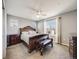 Bedroom featuring a large bed with an intricately carved frame and matching dark wood furniture set at 246 Ash St, Bennett, CO 80102