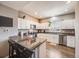 Modern kitchen with granite counters, stainless steel appliances, and an island with bar seating at 246 Ash St, Bennett, CO 80102