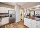 Bright kitchen with stainless steel appliances, granite countertops, and hardwood flooring, offering a modern and functional space at 246 Ash St, Bennett, CO 80102