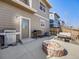 Back patio with gas grills and a cozy brick fire pit, perfect for outdoor gatherings at 246 Ash St, Bennett, CO 80102