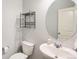 Compact half bathroom with a modern sink, mirror, and neutral wall color at 1018 Mcmurdo Cir, Castle Rock, CO 80108