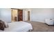 Bedroom featuring a sliding barn door to the en-suite bathroom and plush carpeting at 1018 Mcmurdo Cir, Castle Rock, CO 80108