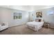 Cozy bedroom features neutral walls and carpet, a window with blinds and elegant floral wall art at 1018 Mcmurdo Cir, Castle Rock, CO 80108