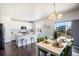 Bright kitchen and dining area featuring modern appliances, a kitchen island, and an outdoor deck at 1018 Mcmurdo Cir, Castle Rock, CO 80108