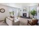 Bright living room with a modern fireplace, neutral tones, and ample natural light at 1018 Mcmurdo Cir, Castle Rock, CO 80108