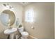 Clean bathroom with pedestal sink and a window at 5482 Wetlands Dr, Frederick, CO 80504