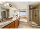 Bathroom with double vanity, soaking tub, and shower at 5482 Wetlands Dr, Frederick, CO 80504