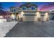 Two-story house with a three-car garage and snow-covered driveway at 5482 Wetlands Dr, Frederick, CO 80504