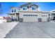 Charming two-story home with a three car garage and covered porch on a sunny day in winter at 5482 Wetlands Dr, Frederick, CO 80504