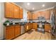 Well-equipped kitchen featuring stainless steel appliances and wood cabinets at 5482 Wetlands Dr, Frederick, CO 80504