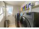 Laundry room with washer, dryer, and storage shelves at 5482 Wetlands Dr, Frederick, CO 80504