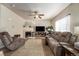 Living room with fireplace, large TV, and comfy seating at 5482 Wetlands Dr, Frederick, CO 80504