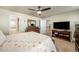 Main bedroom with king-size bed, TV, and ensuite bathroom at 5482 Wetlands Dr, Frederick, CO 80504