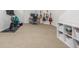 Finished basement area used as a flex space featuring exercise equipment and desk space at 3433 N Wabash St, Denver, CO 80238