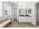 Bright bathroom featuring a double vanity, round mirrors, and ample natural light at 3433 N Wabash St, Denver, CO 80238