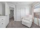Bedroom featuring a white rocking chair, soft textures, and comforting decor at 3433 N Wabash St, Denver, CO 80238