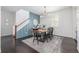 Dining room with statement wall, modern chandelier, and stairs leading to the second floor at 3433 N Wabash St, Denver, CO 80238
