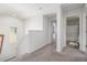 Bright hallway featuring neutral carpet and a bathroom located off to the right at 3433 N Wabash St, Denver, CO 80238