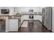 Modern kitchen boasts stainless steel appliances, granite countertops, and white cabinetry at 3433 N Wabash St, Denver, CO 80238