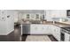 Open concept kitchen with stainless steel appliances, granite countertops, and views into the living area at 3433 N Wabash St, Denver, CO 80238