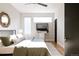 Spacious bedroom with wood floors, large windows, and a ceiling fan at 1836 Grove St # 107, Denver, CO 80204
